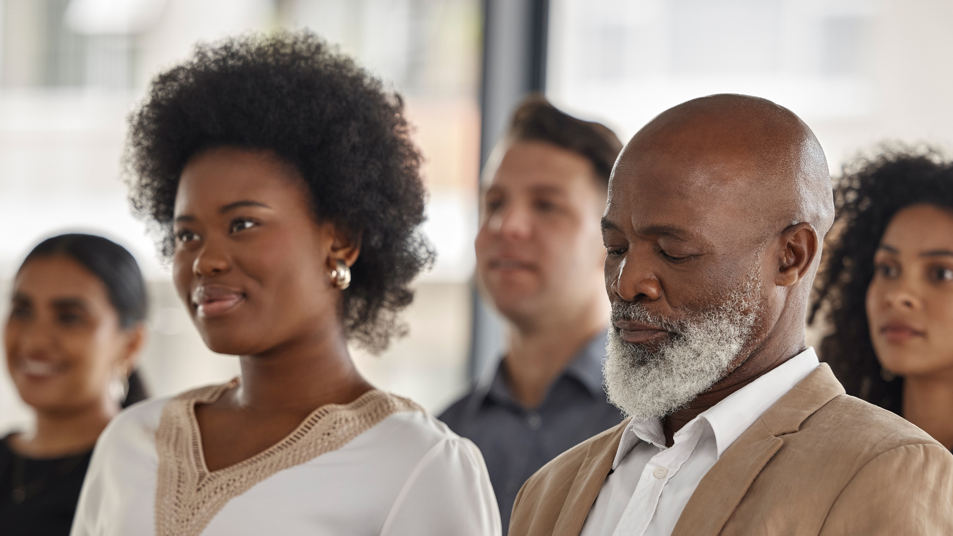 An image of Black and Brown people attending a meeting